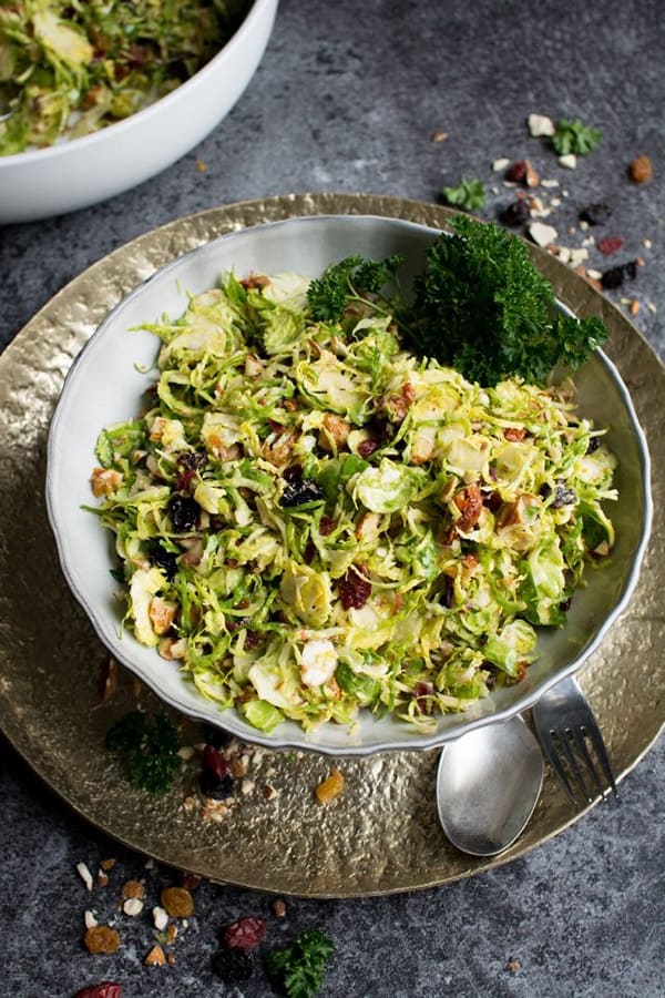 Raw Brussels Sprouts Salad with Dried Fruit Brussels Sprouts can be quite boring. But this raw brussels sprouts salad with dried fruit, nuts and lots of other good stuff will definitely change your mind. I am not a big fan of brussel sprout myself, but the crunchy texture of this salad, with the sweet and salty flavours, create a Christmas salad you won’t be able to get enough of!