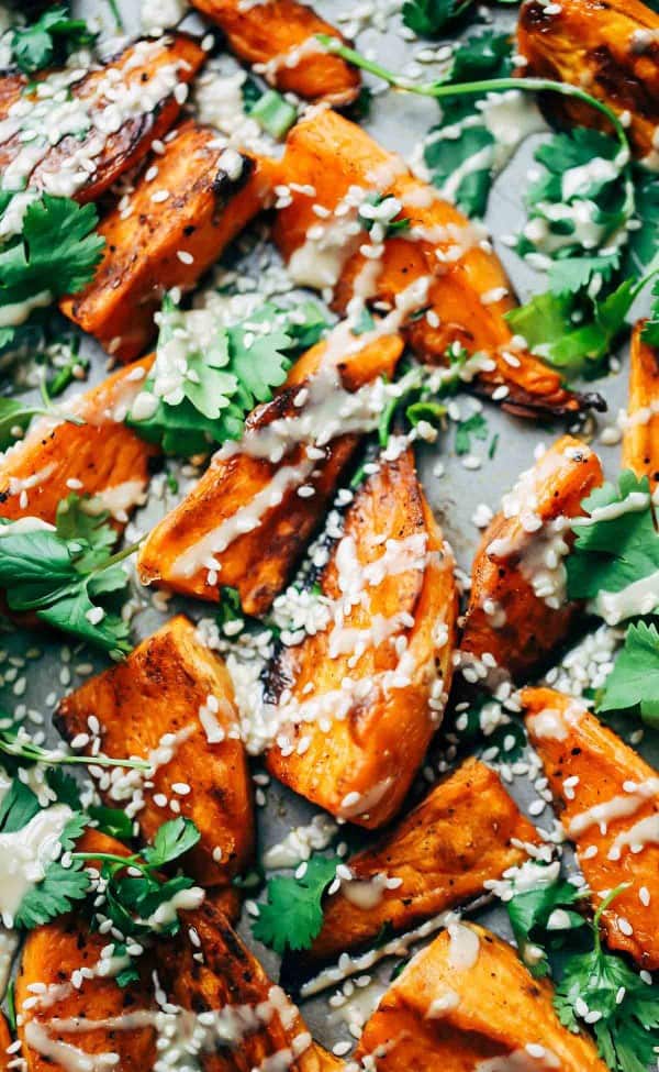 30-minute sesame roasted sweet potatoes Who doesn't love some crispy roasted sweet potatoes? Topped with tahini, sesame oil, cilantro, and sesame seeds these roasted sweet potatoes are easy to make and delicious.
