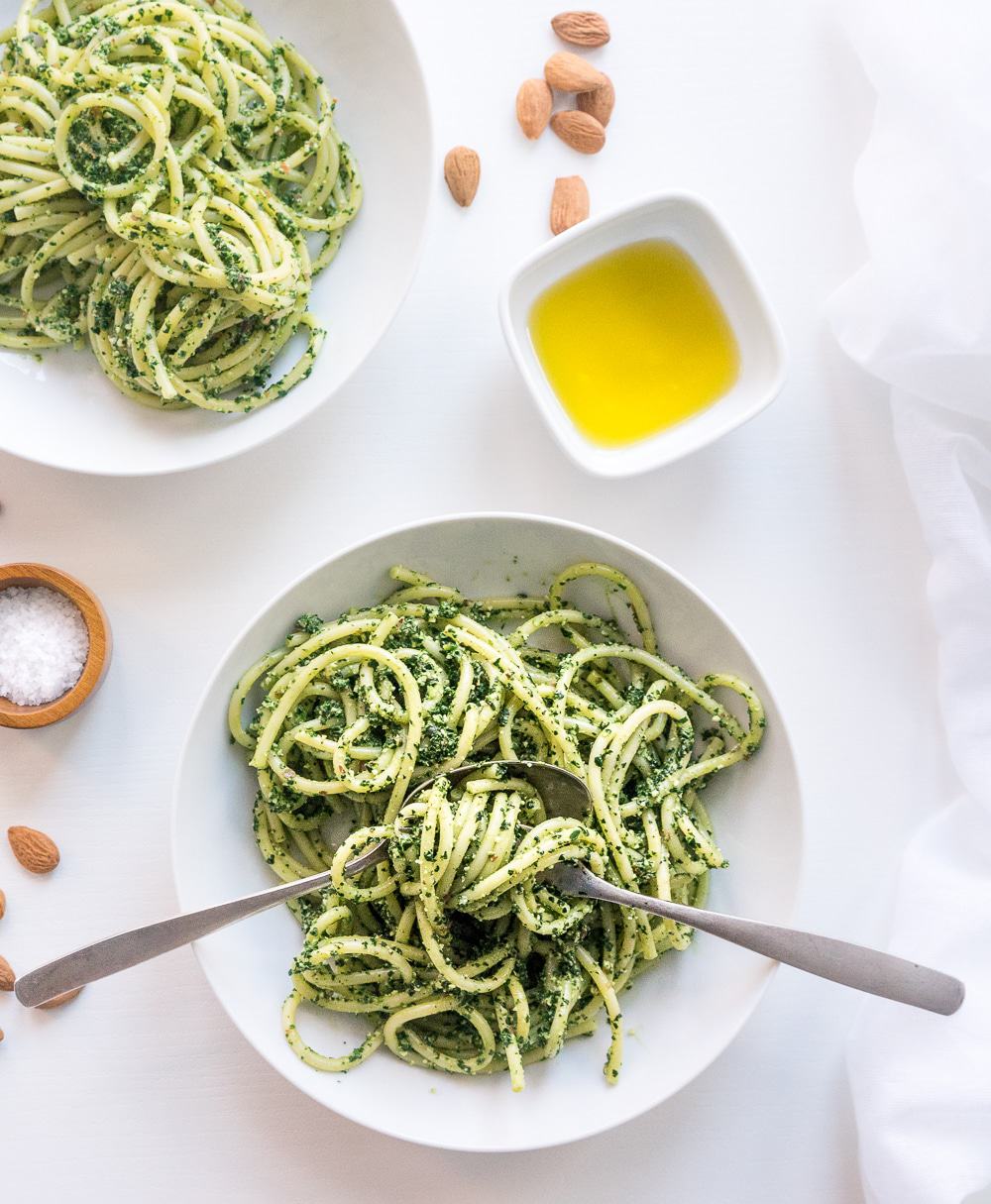 Top view of vegan Tuscan kale pesto pasta in a white plate
