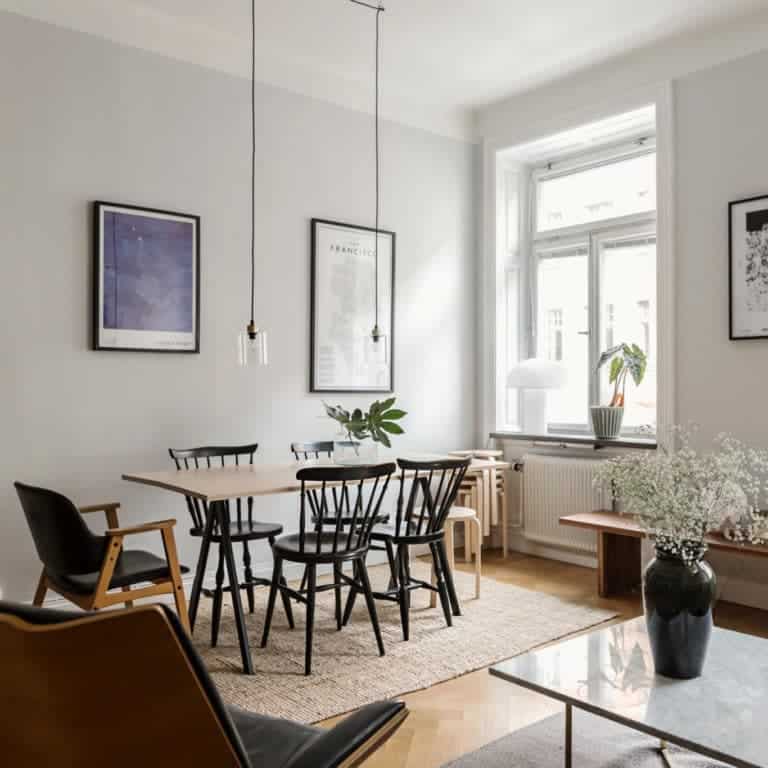 A Scandinavian inspired living room with grey walls and big windows. This dreamy Swedish apartment has the right balance between functionality and style. By looking at this, you will find out all the tips you need to find out how to decorate a small apartment.