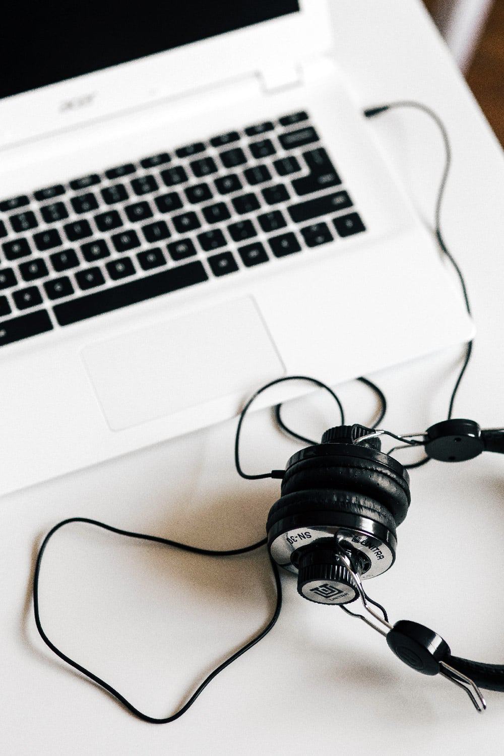 View of laptop with headphones. All you need to make money as a transcriptionist working from home.