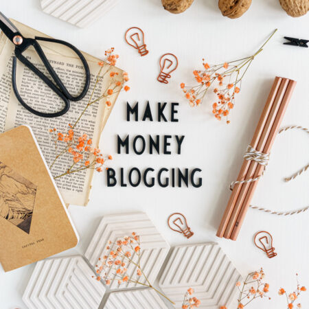 Top down view of desk with letters saying "Make Money Blogging"