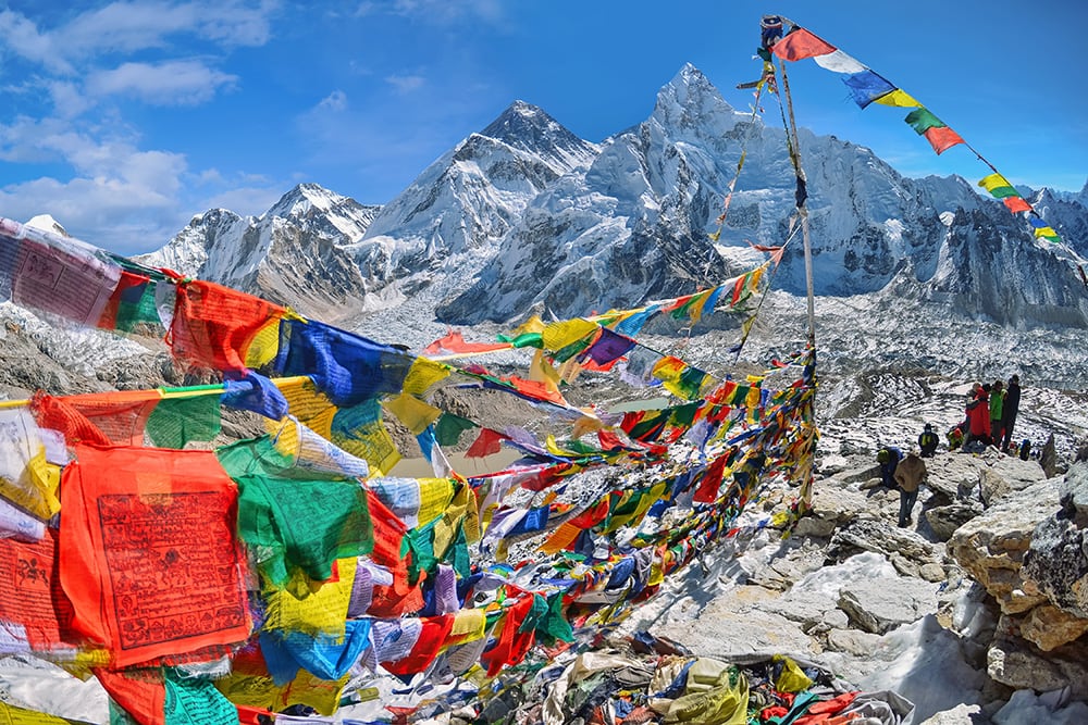 View of Mount Everest and Nuptse with Buddhist prayer flags, in Nepal