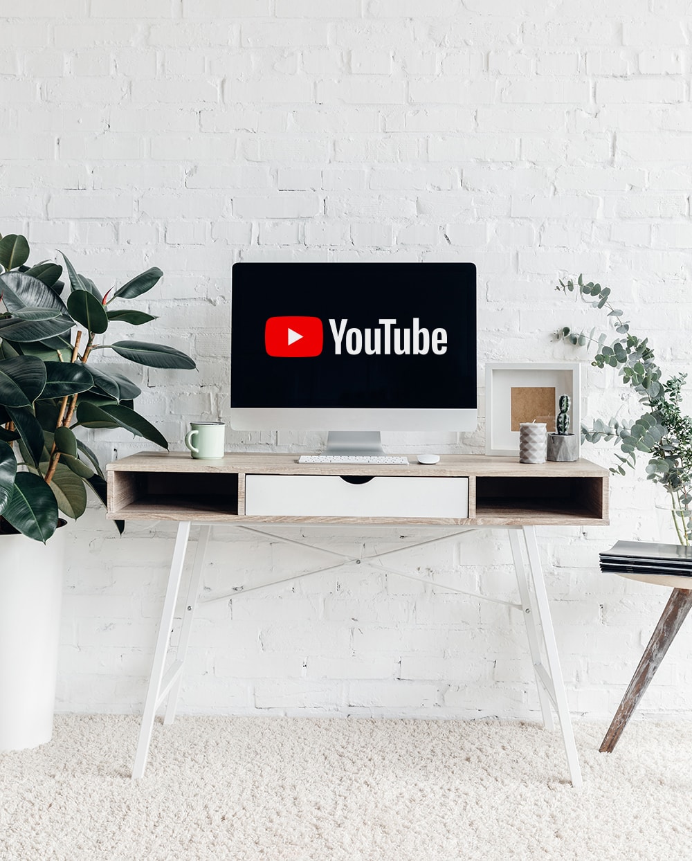 Modern desk with monitor with YouTube logo on it