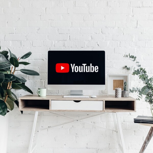 Modern desk with monitor with YouTube logo on it