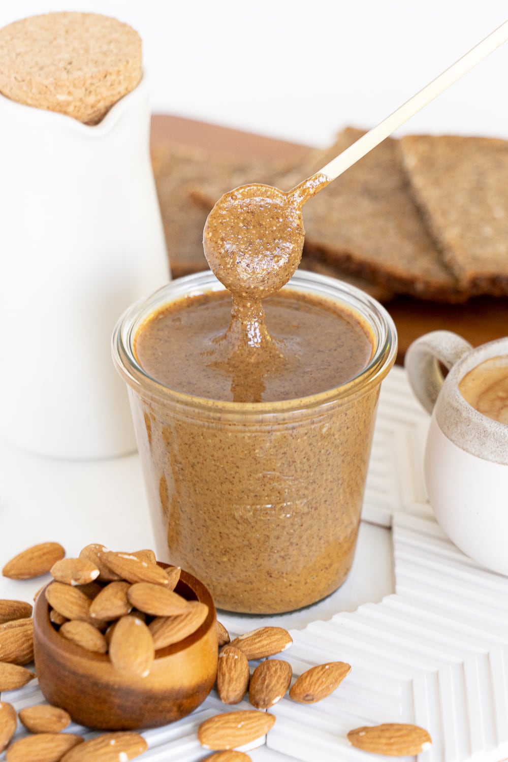 Smooth almond butter with spoon in it