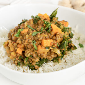 A 3/4 view of a plate with coconut lentil curry and rice