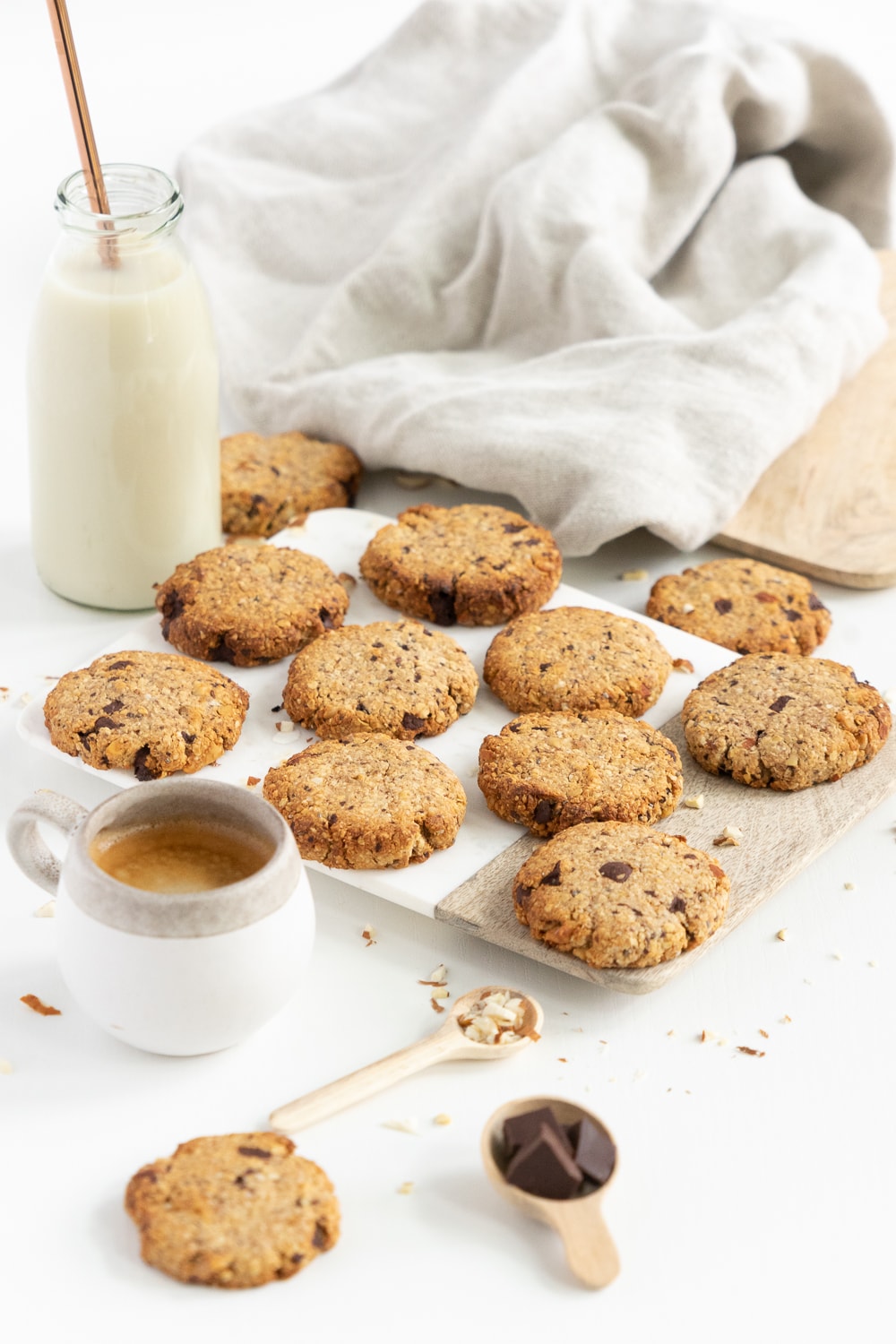 3/4 view of a pile of breakfast cookies with coffe and milk