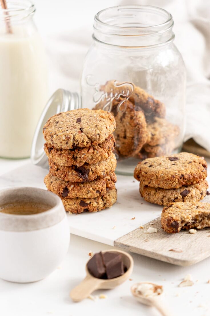 Breakfast cookies on a board with a cookie jar in the background.