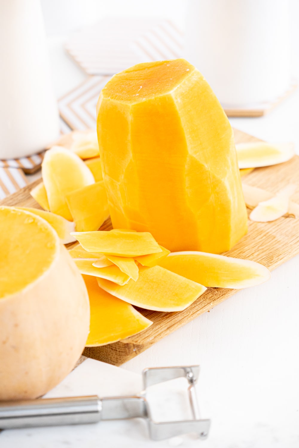 Peeled butternut squash on a cutting board