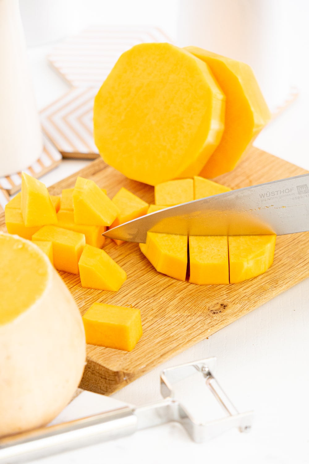 Hands cutting a butternut squash with a knife