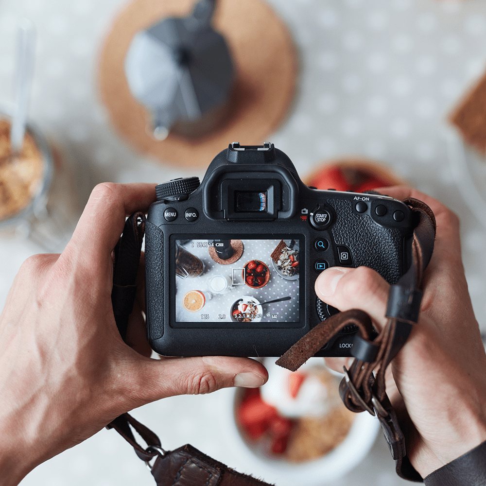 Photographer taking food pictures for his small business