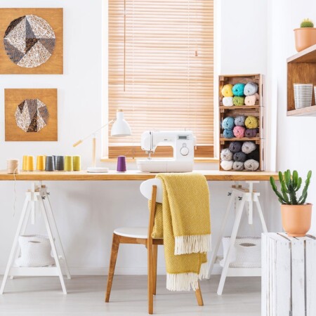 Colourful room interior with a desk, sewing machine and threads