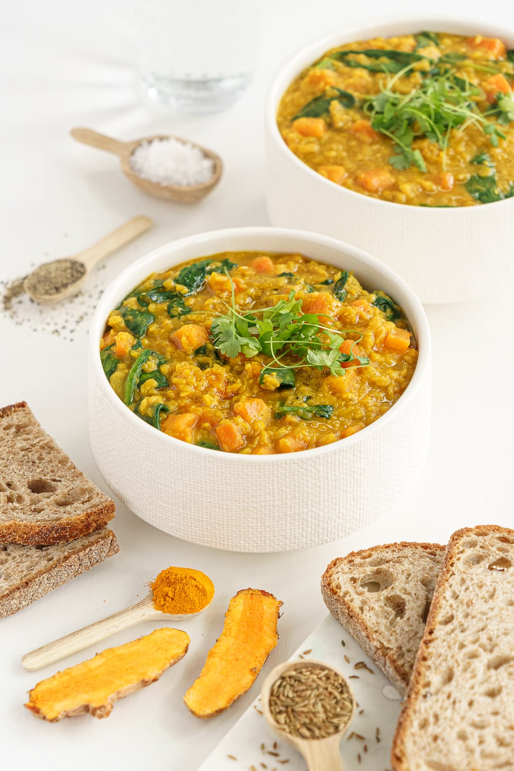 Two bowls filled with red lentil soup 