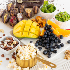 display of lots of healthy snack ideas options like fruit and popcorns