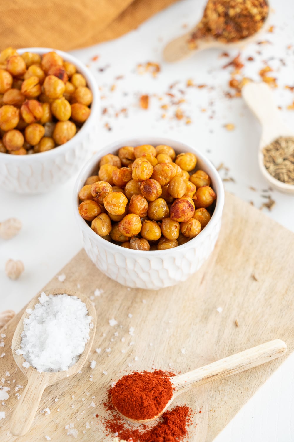 Close up of a small white bowl full of roasted chickpeas