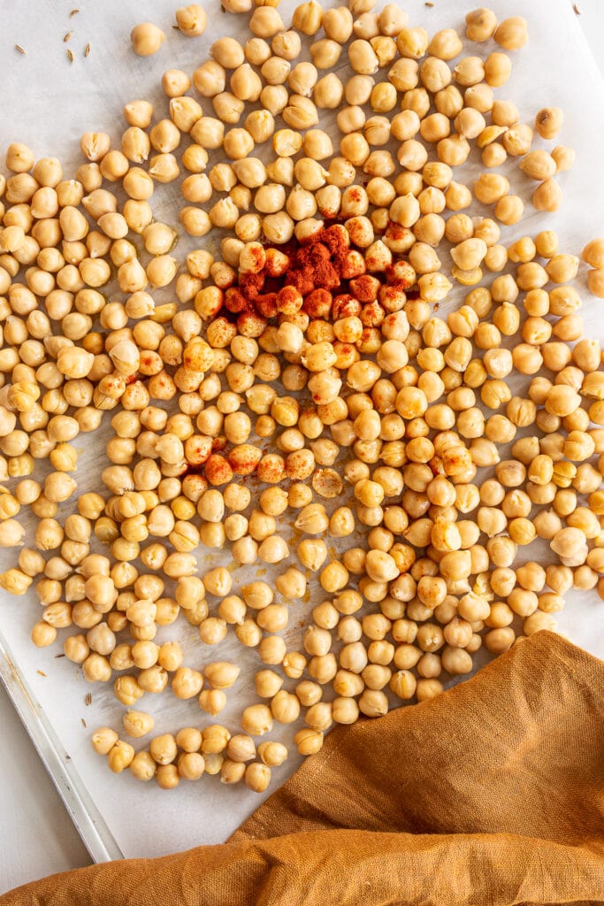 Top view of chickpeas on baking sheet with spices