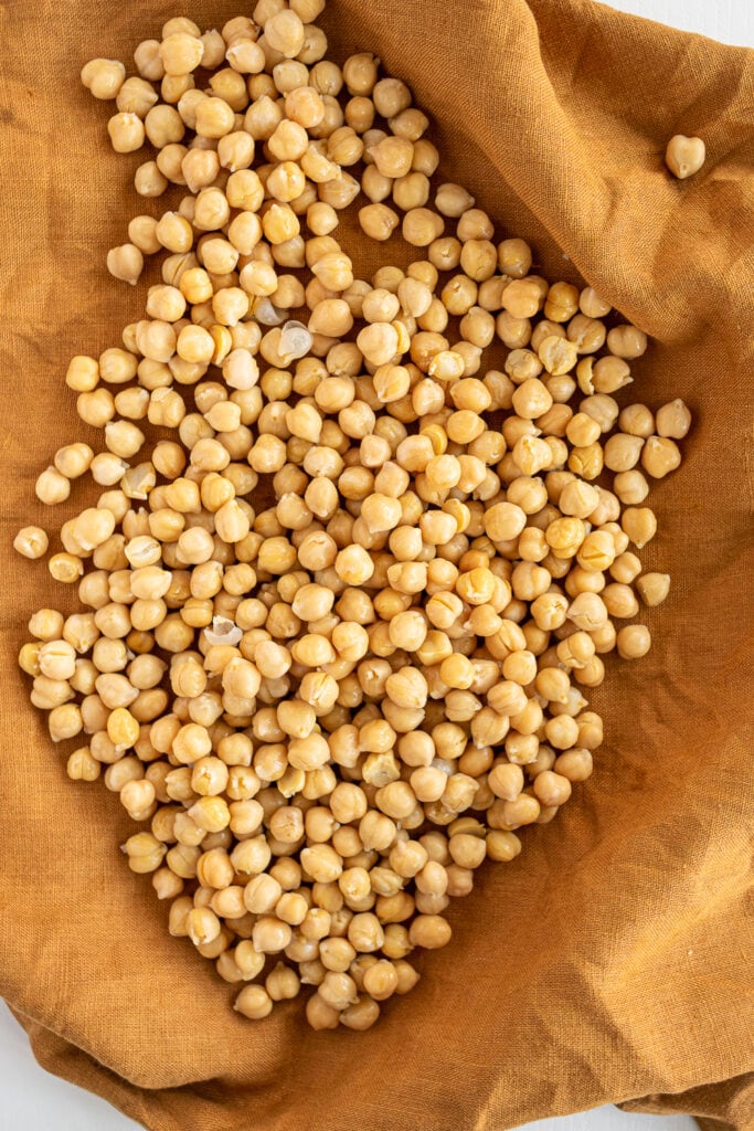 Cooked chickpeas drying in a towel