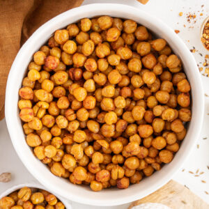 Top view of white bowls full of roasted chickpeas