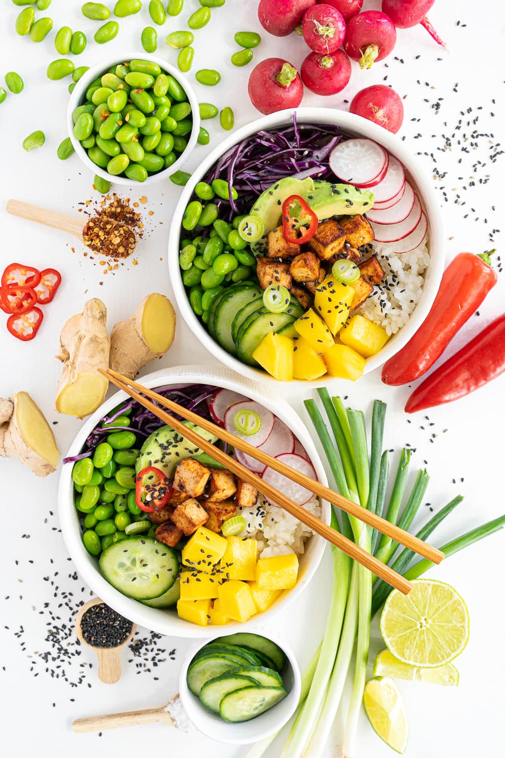 Assembling the tofu bowl: adding mango, crispy tofu, and toppings