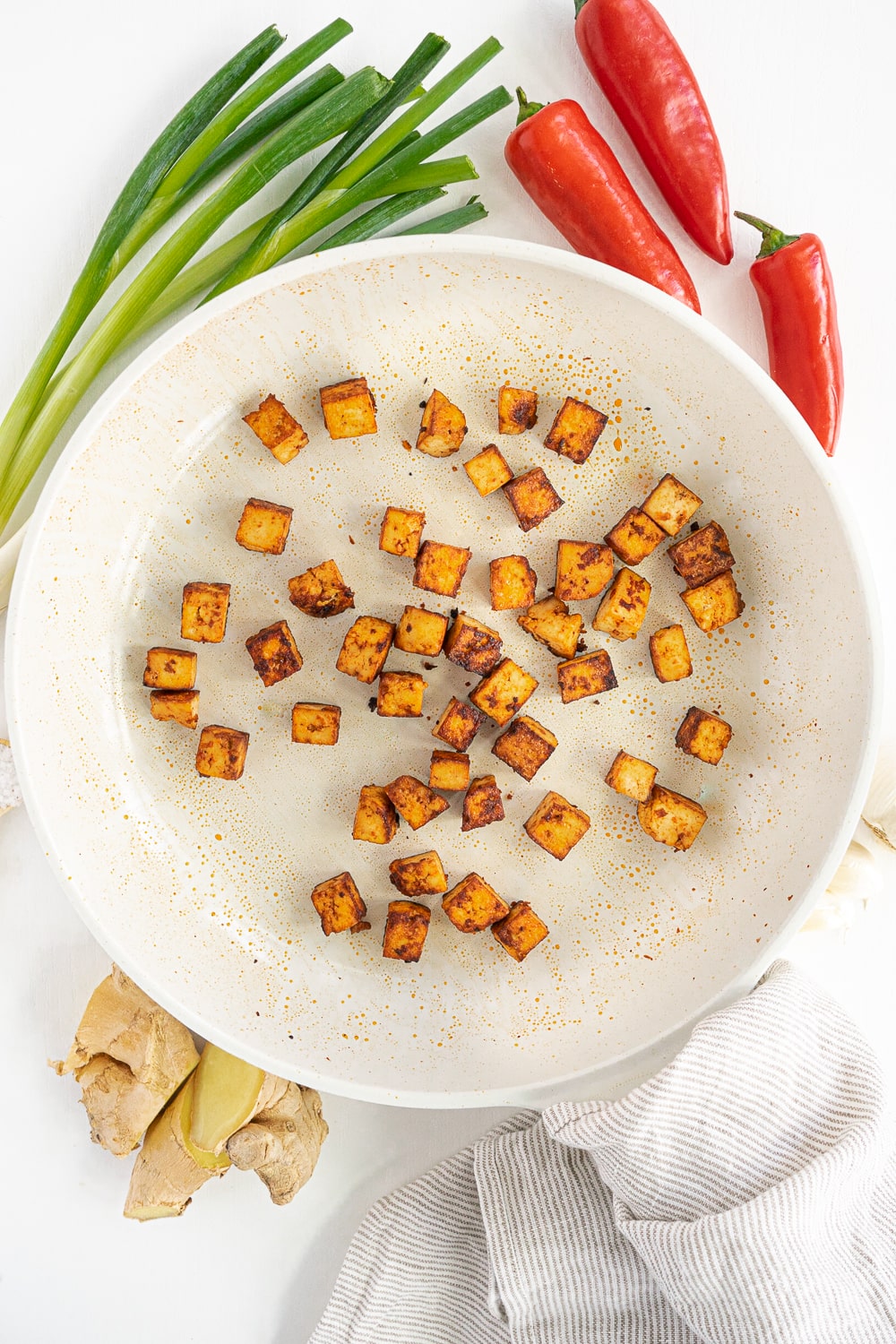Tofu cooking in a frying pan