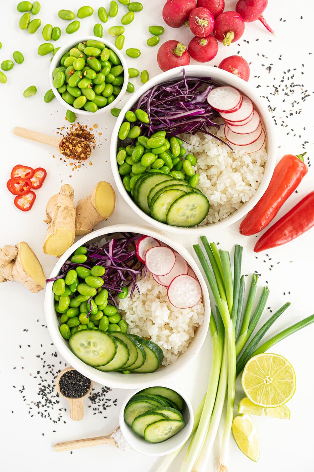 Assembling the tofu bowl: adding edamame and pickled cucumbers