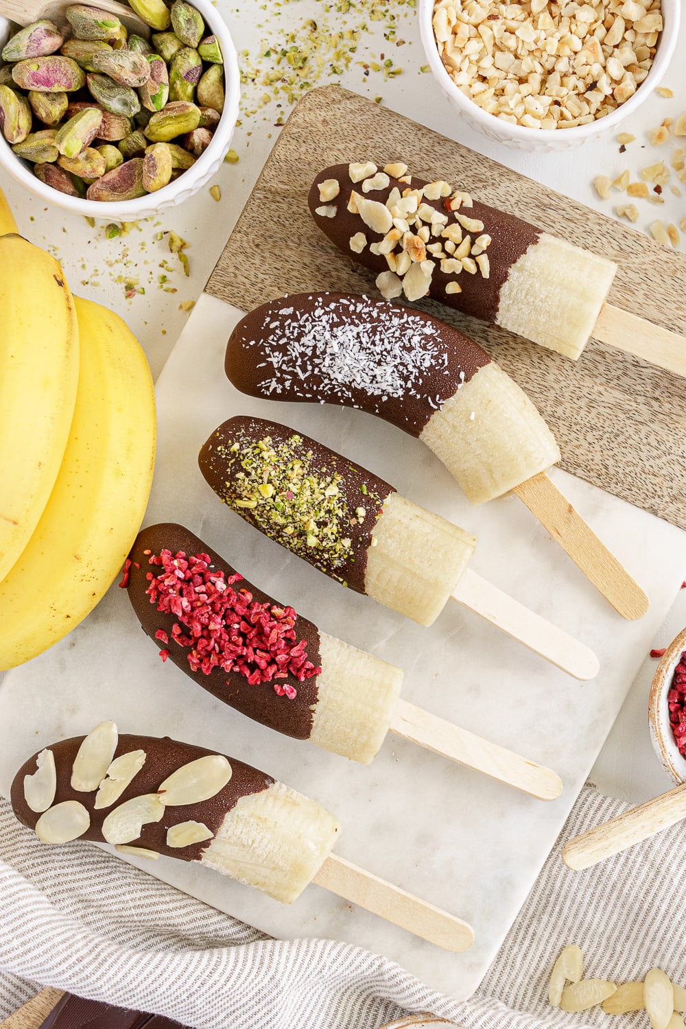 close up of chocolate bananas with different toppings