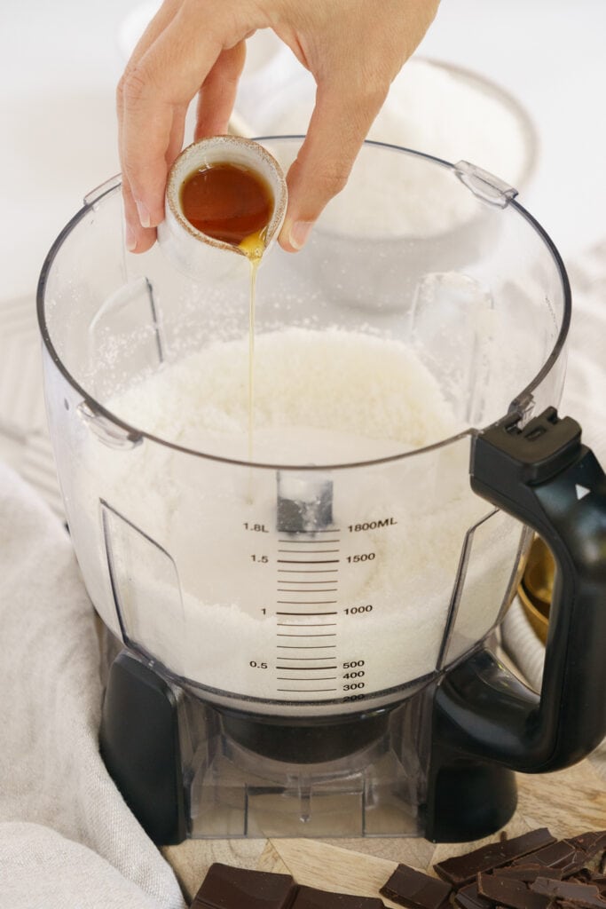 adding maple syrup in a food processor