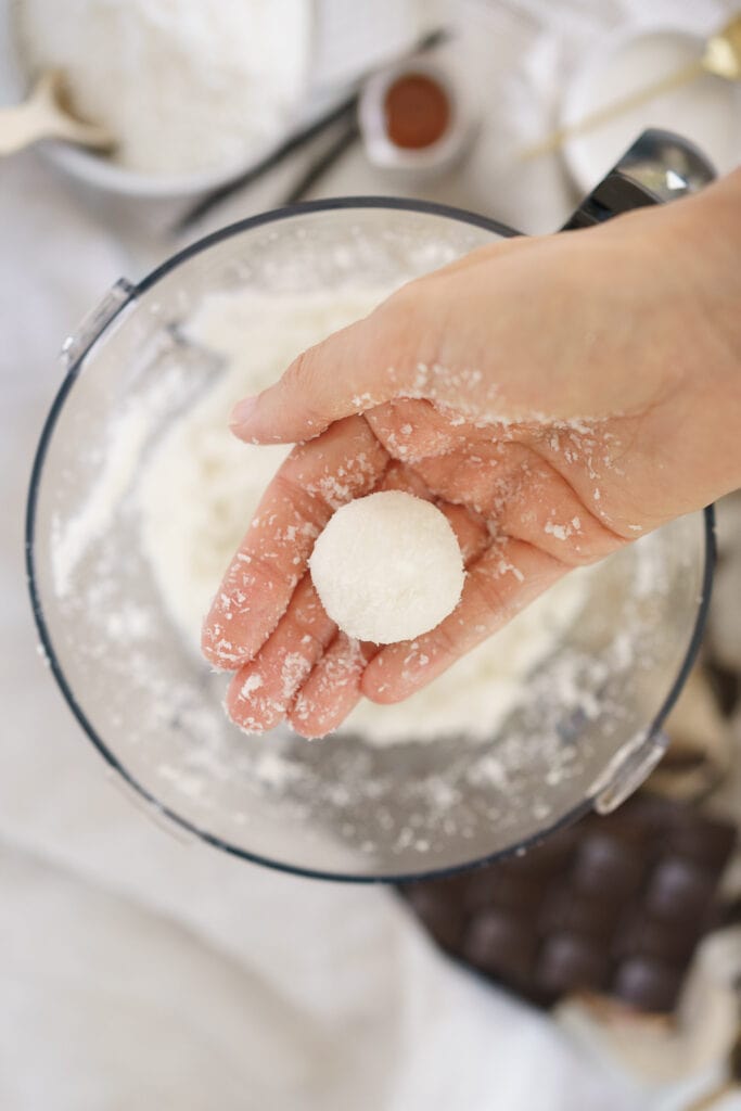 hand forming a bowl with coconut mixture
