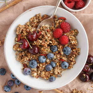 Oil-free granola in a bowl with fruit and milk