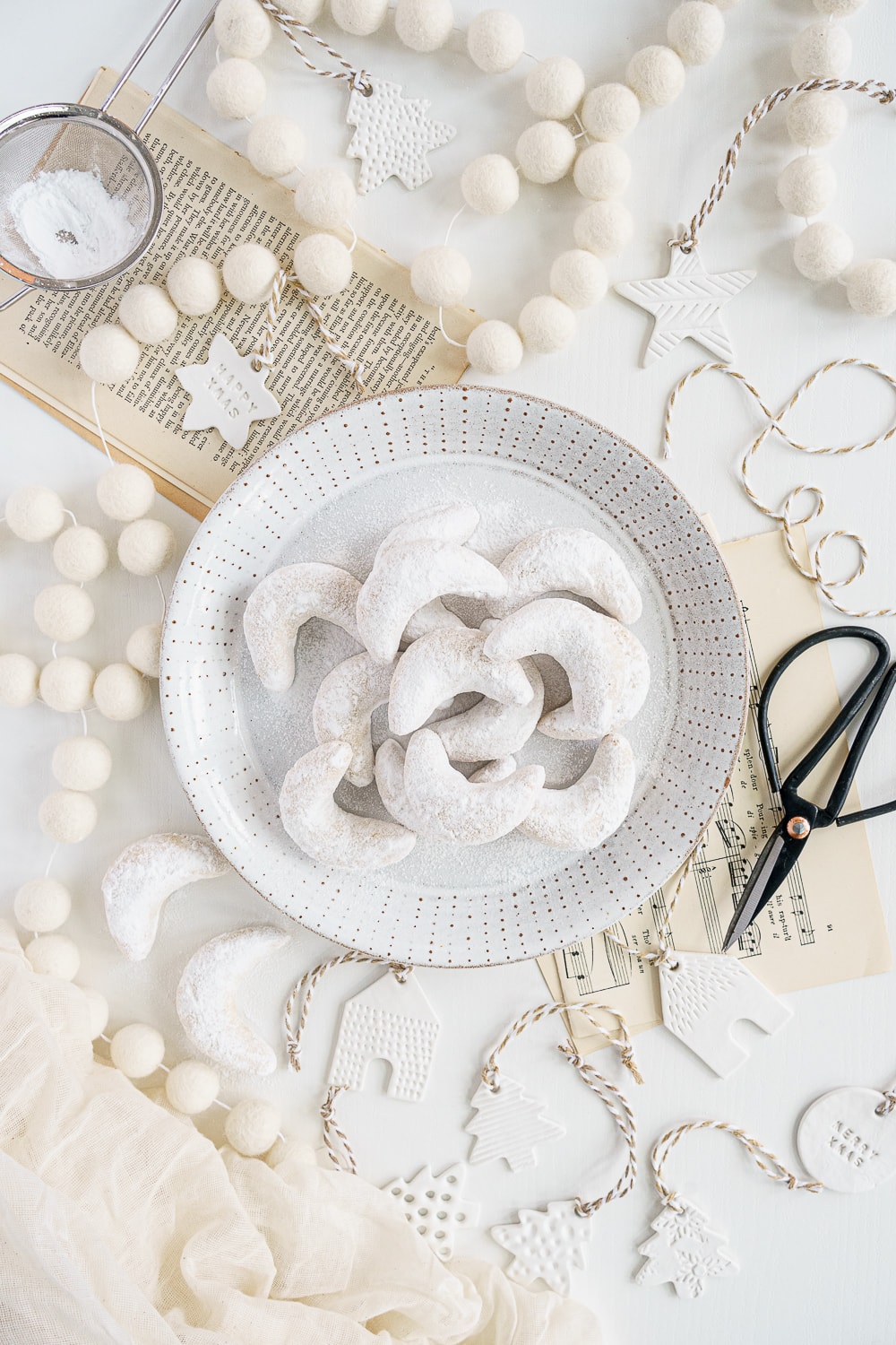 Top view of plate with almond crescent cookies