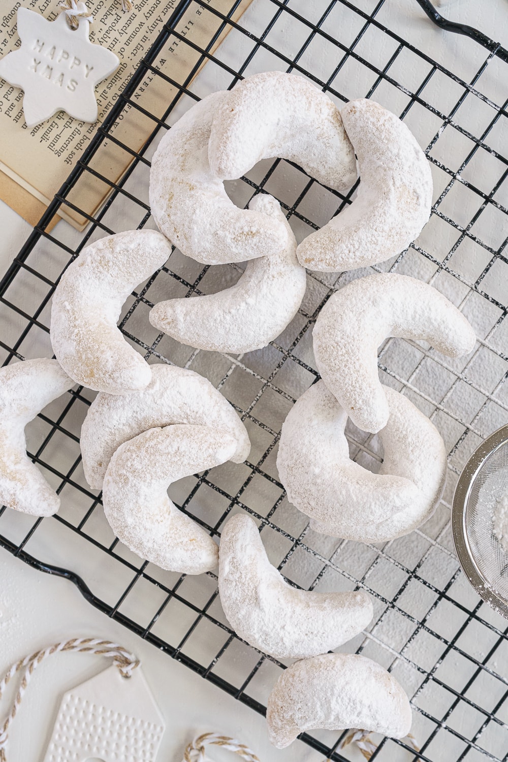 close up of almond crescent cookies on a cooling rack