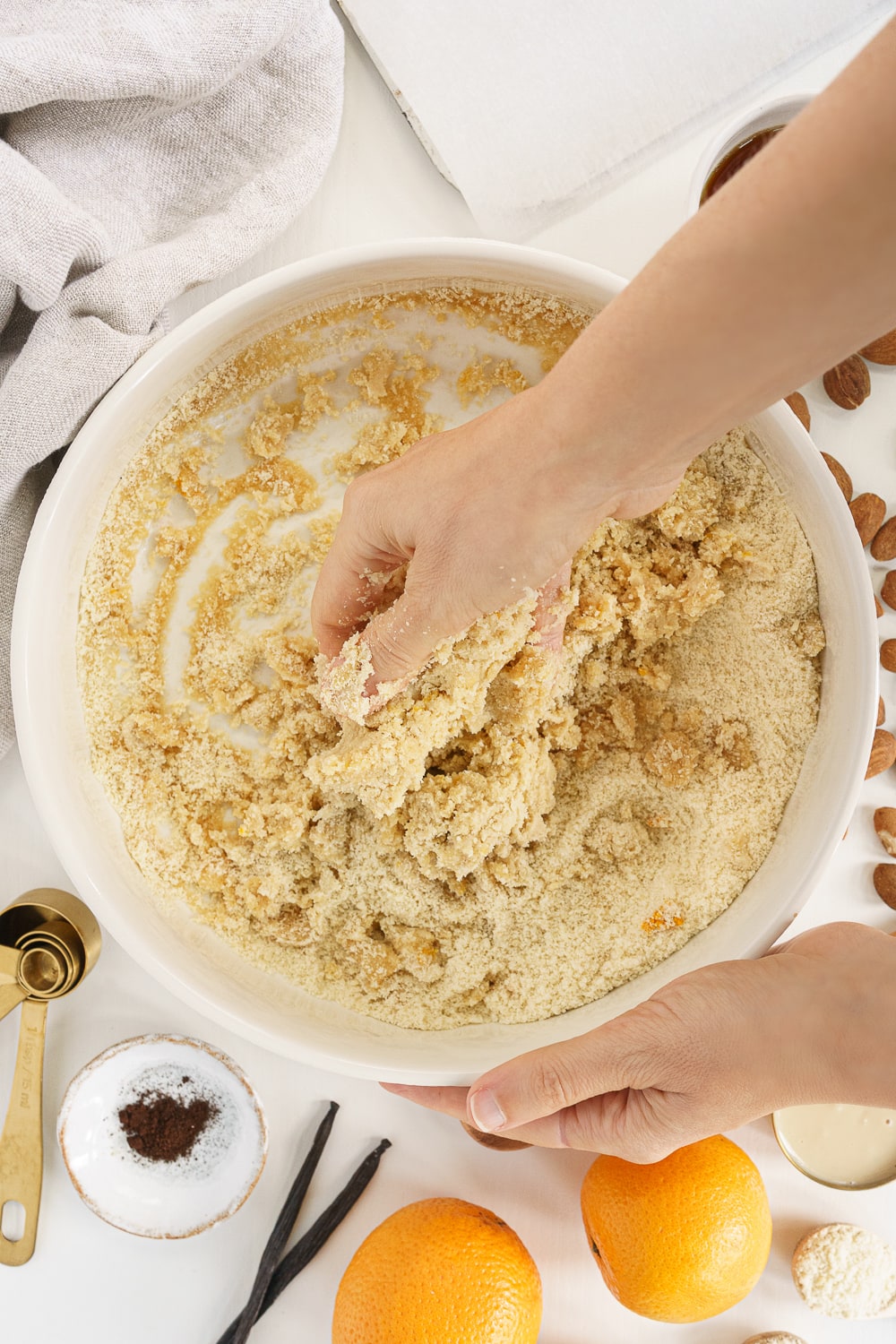 hand mixing dough for almond crescent cookies