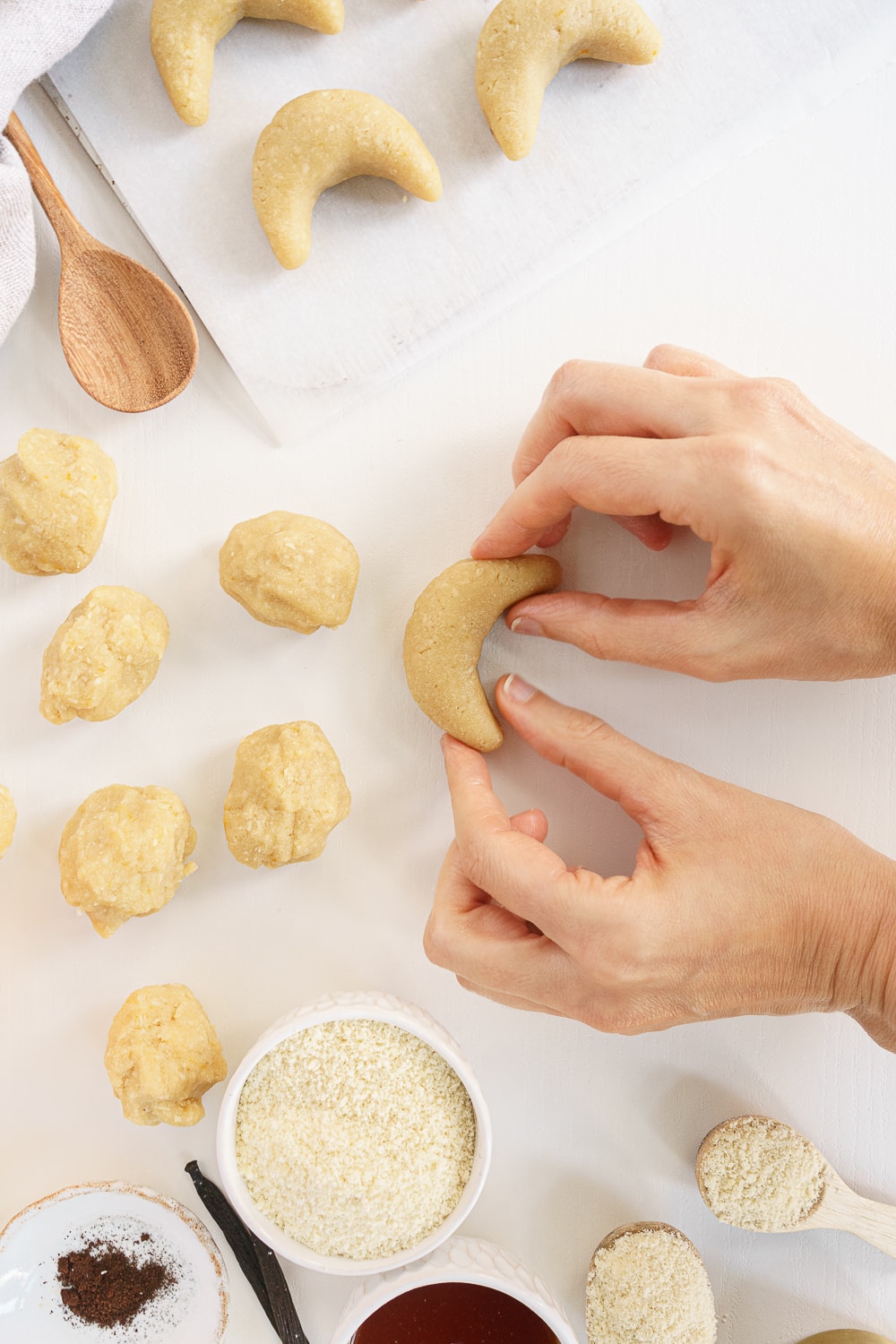hands shaping crescent cookies
