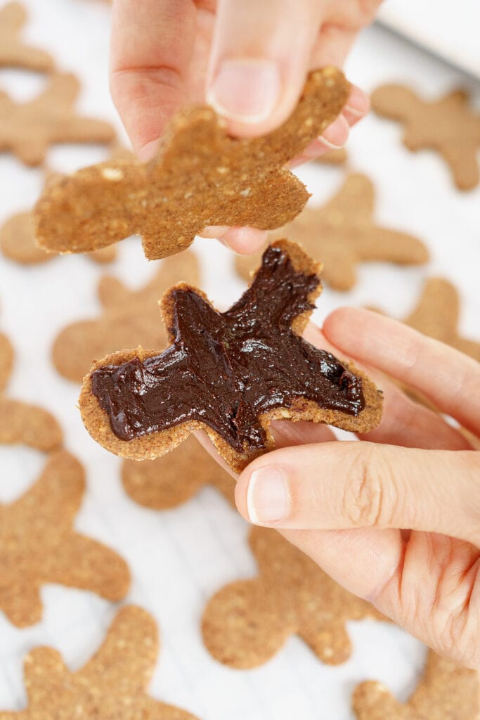 spreading chocolate filling on gingerbread man