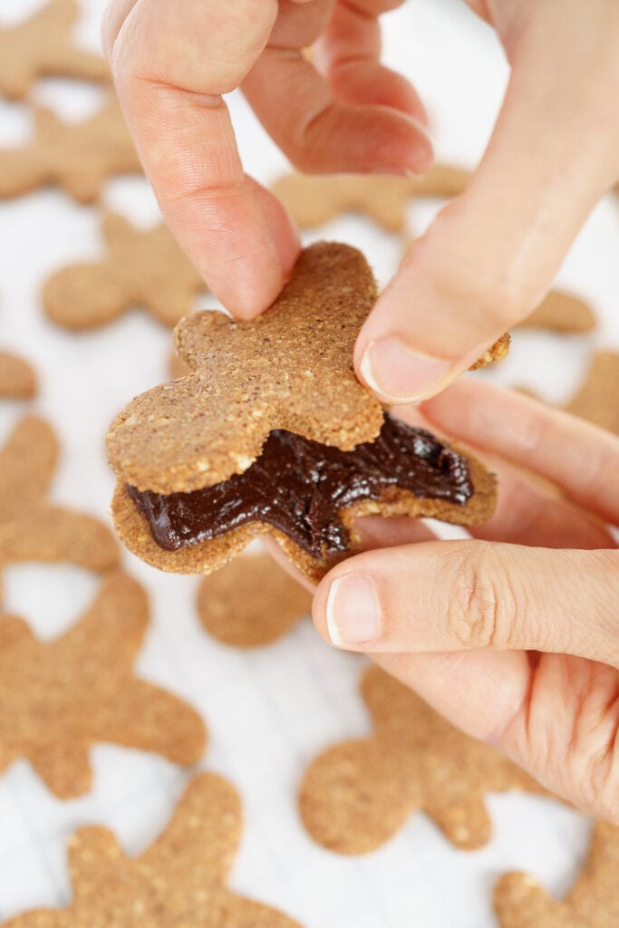Making a cookie sandwich with 2 gingerbread men