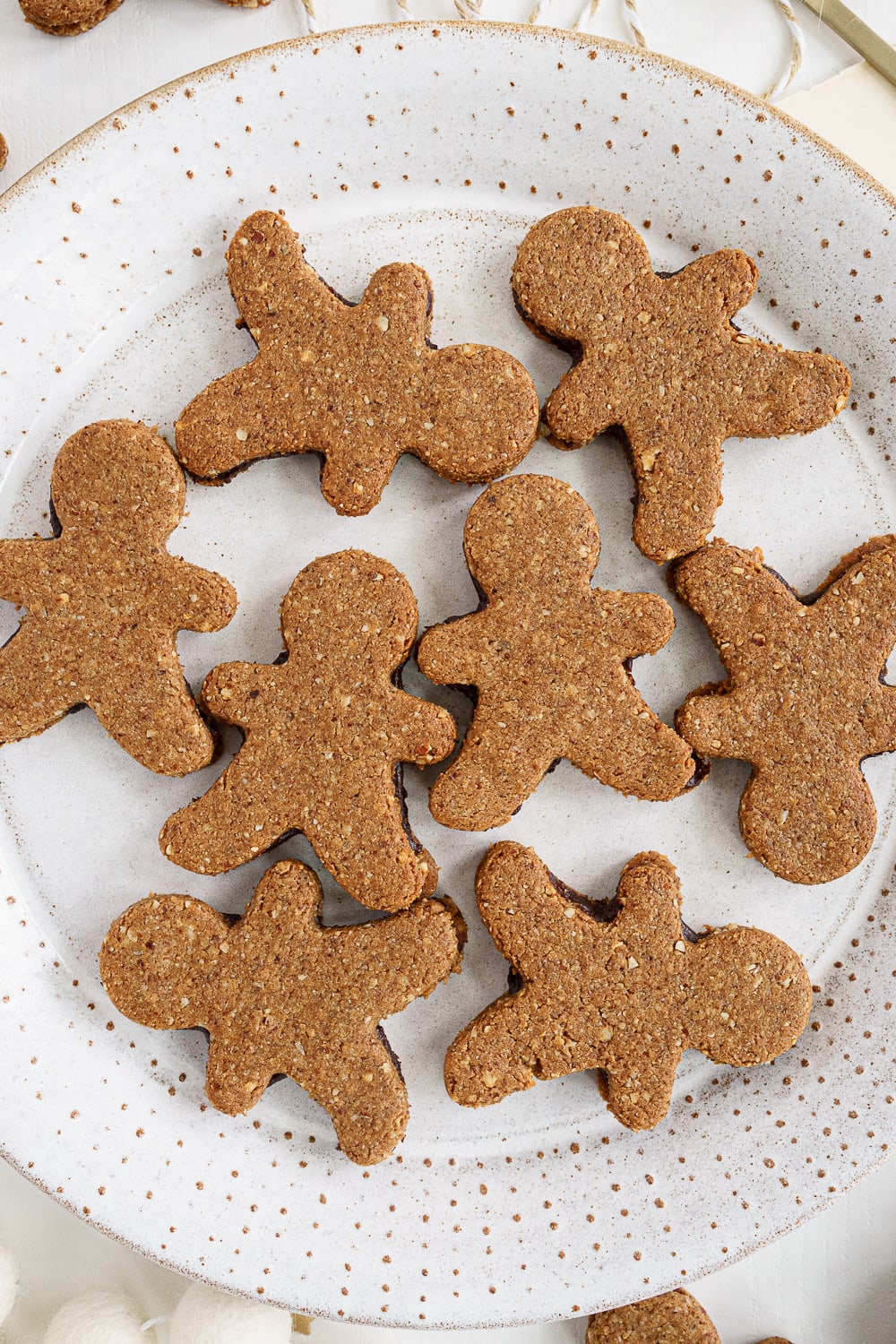 close up of plate filled with gingerbread man sandwich cookies