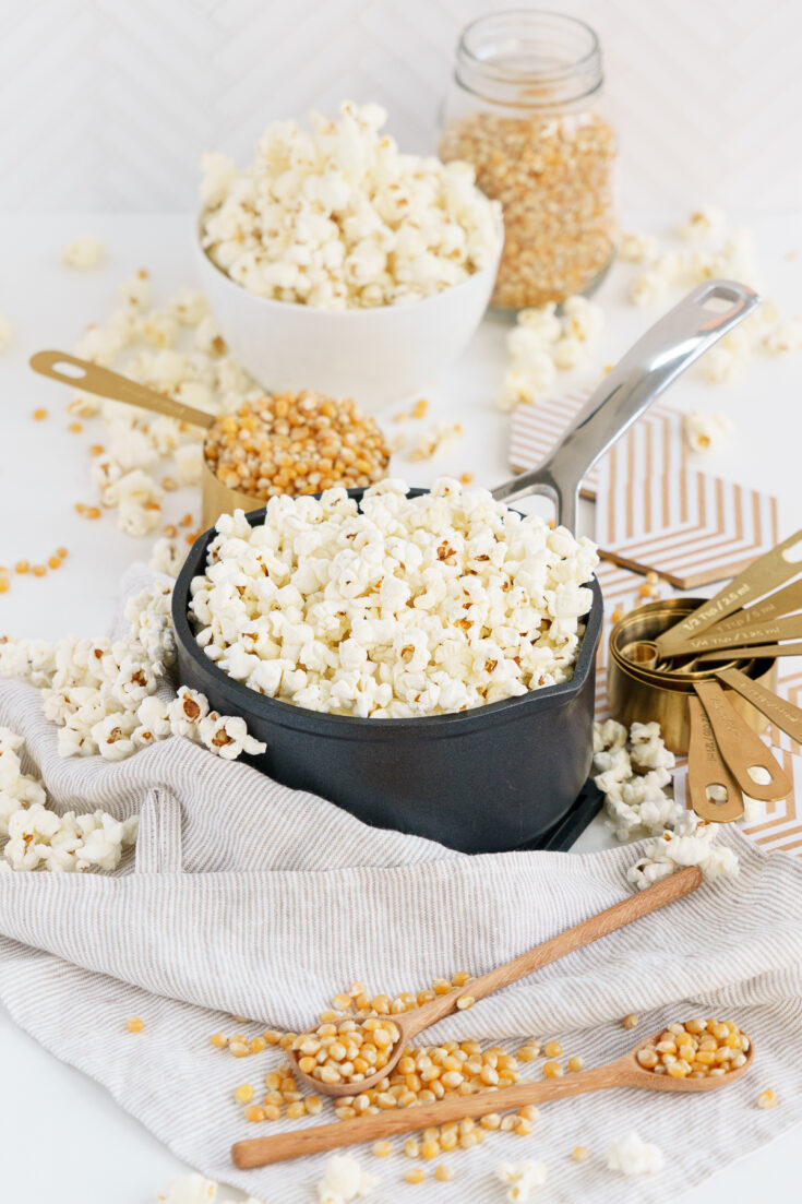 Healthy popcorn on a kettle surrounded by corn kernels