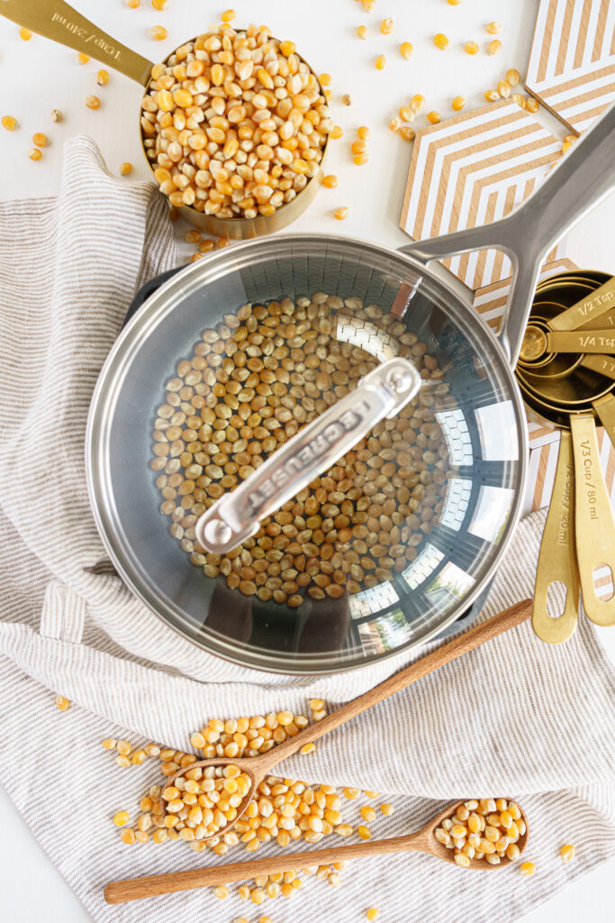 Popcorn kernels in a pot covered with lid