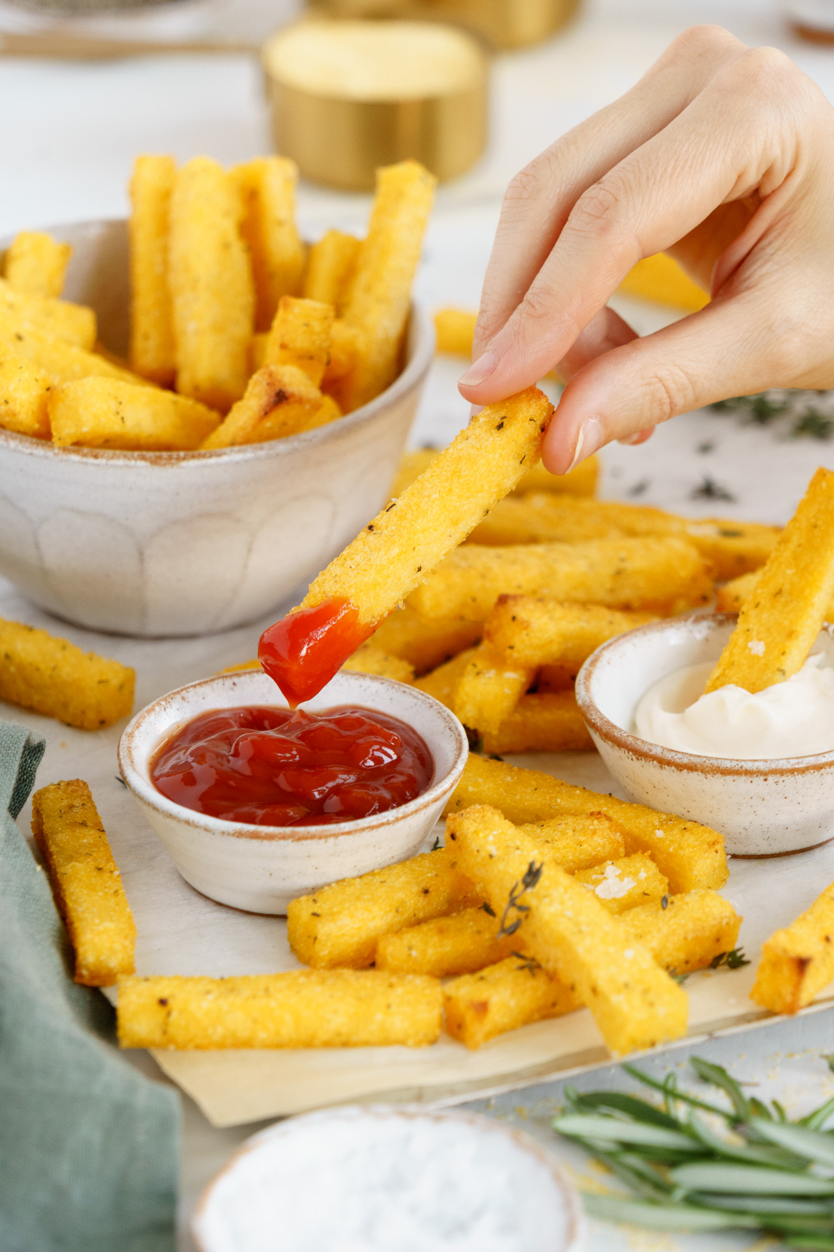 Delicious crispy baked polenta dipped in ketchup