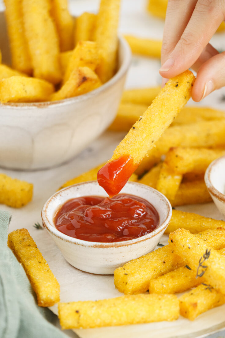 Delicious crispy baked polenta dipped in ketchup