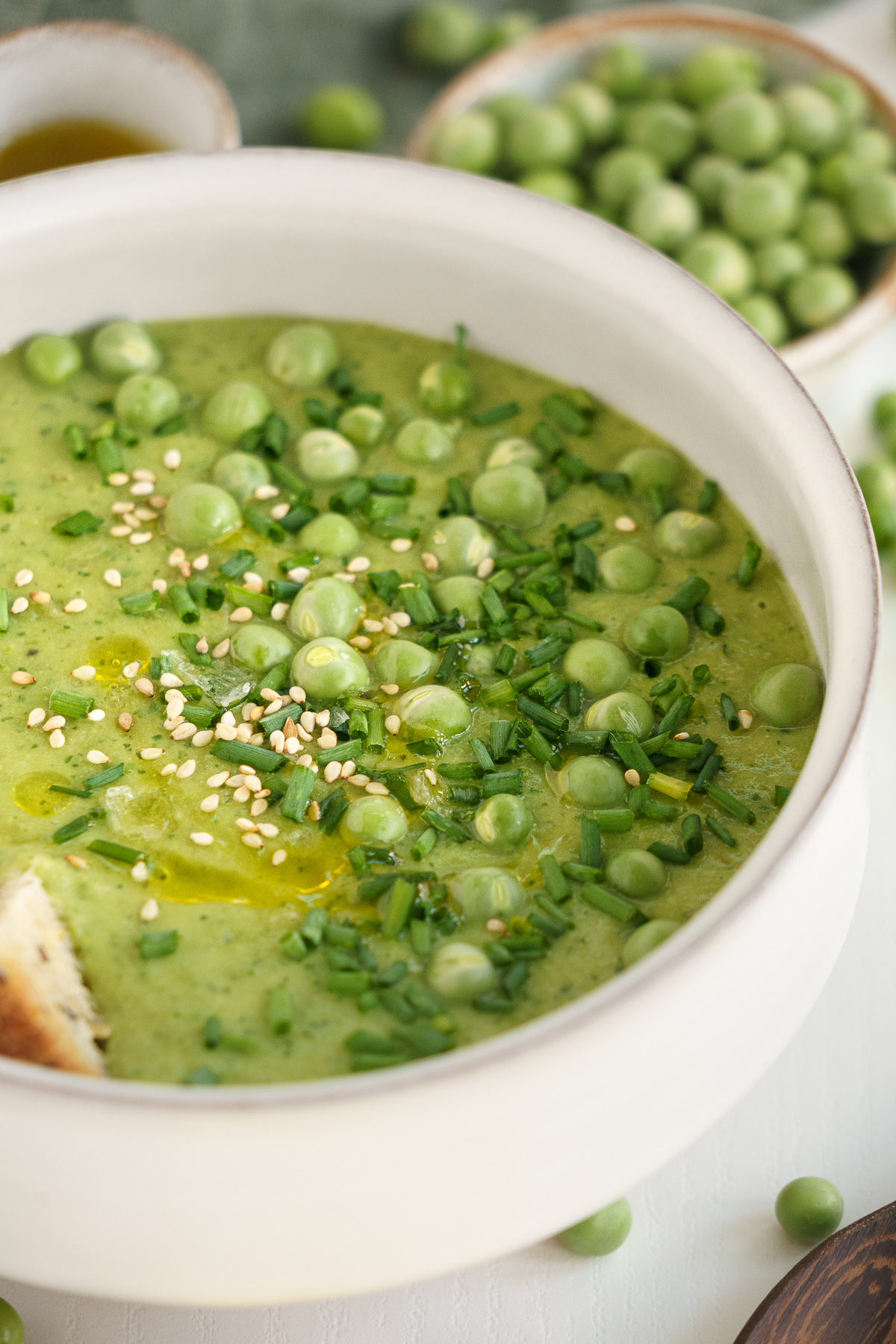 Finished bowl of fresh pea soup garnished with lemon zest.