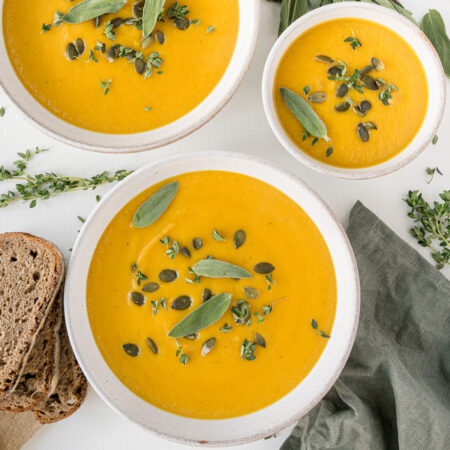 top down view of plates filled with vegan butternut squash soup