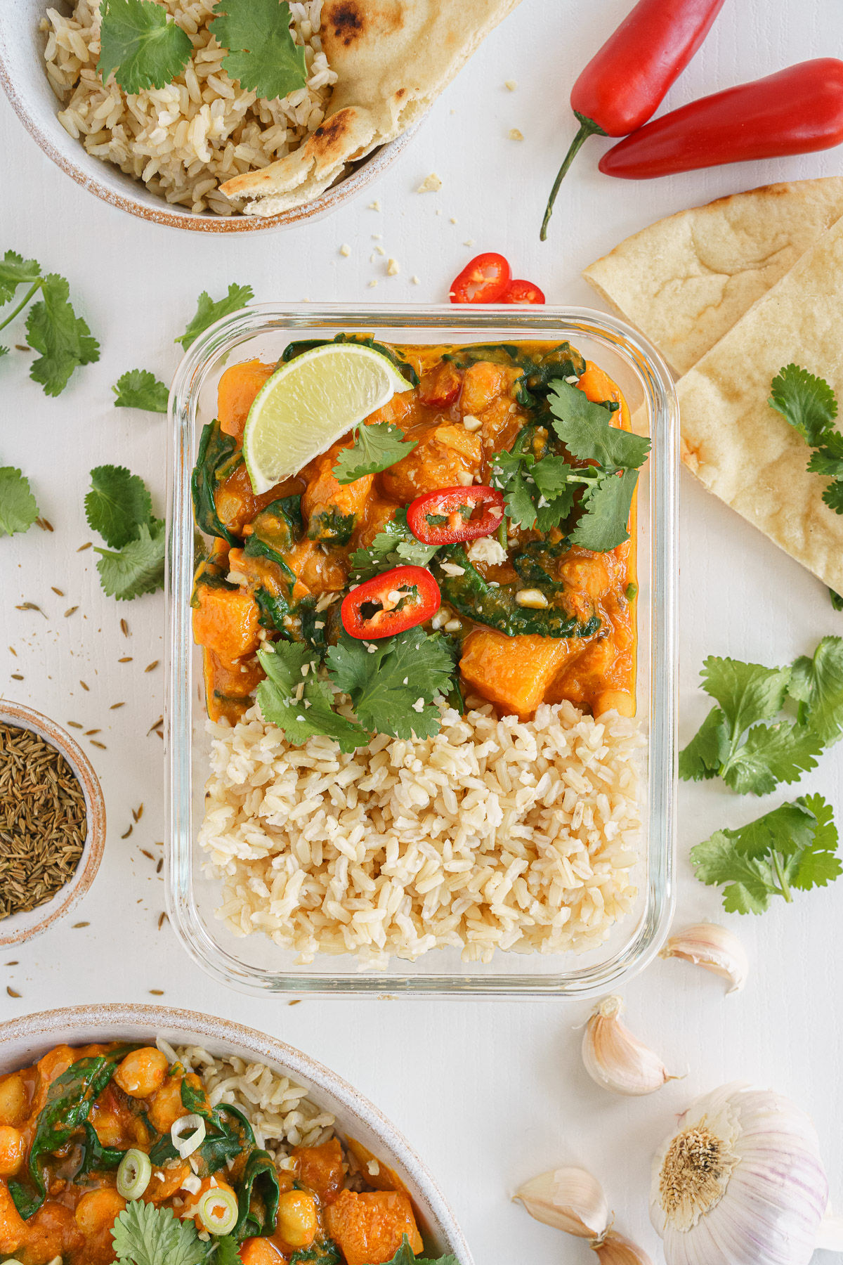 Butternut squash curry packed with rice in a container to carry on the go.