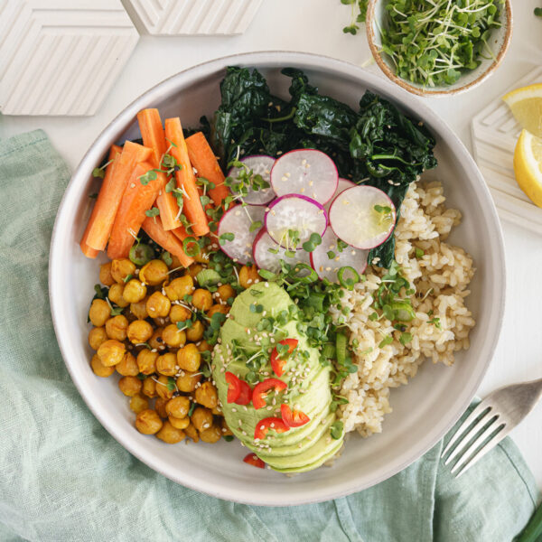 Chickpeas, veggies, grains and avocado in a buddha bowl.