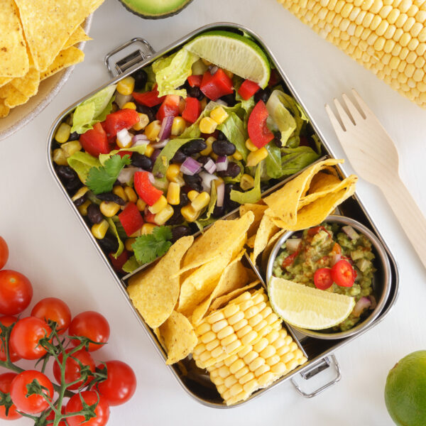 Mexican bento box with corn and black bean salad and fresh corn.