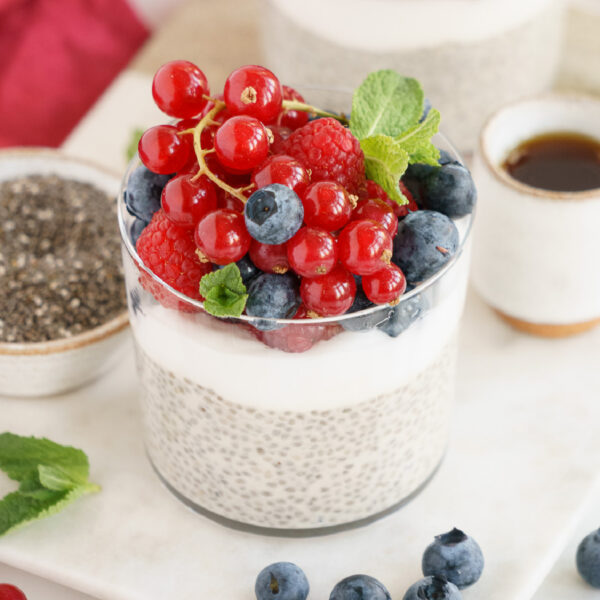 Glass of vanilla chia pudding with berries.