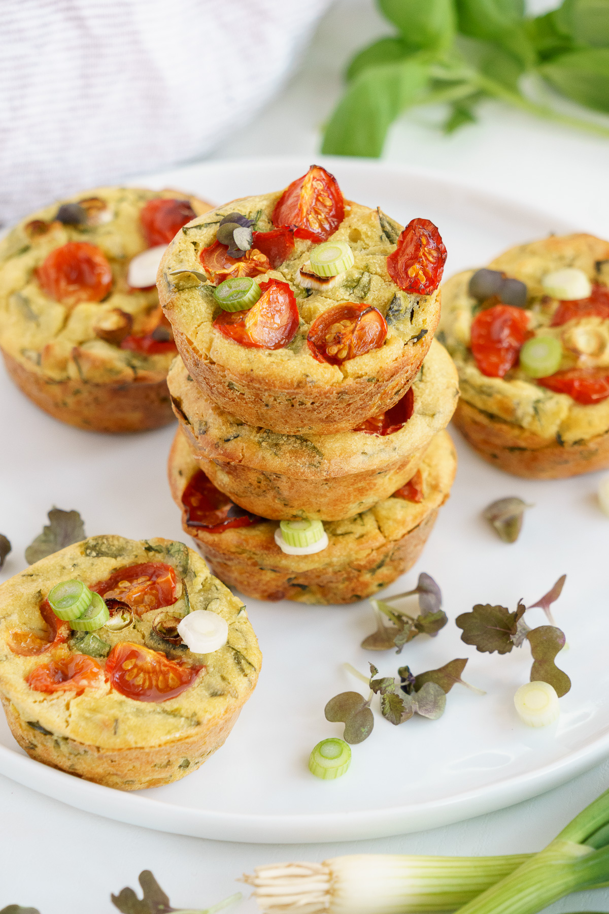 A stack of vegan egg muffins on a plate.