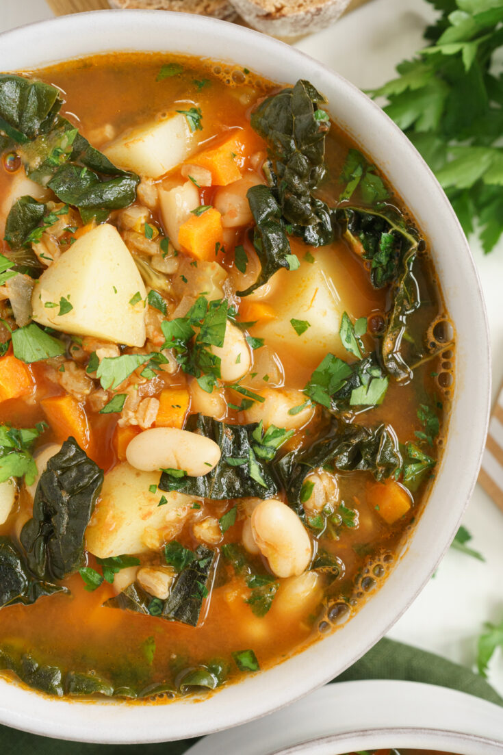 Overhead closeup of farro soup in a bowl.