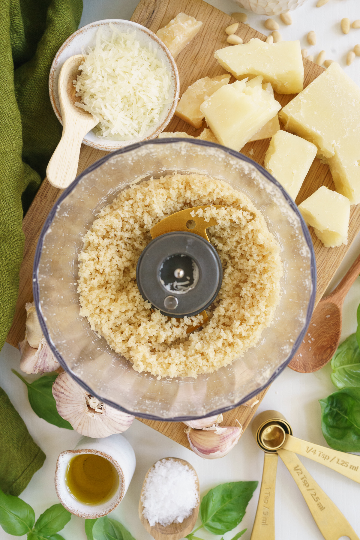Pine nutes, garlic, and cheese mixed in a food processor